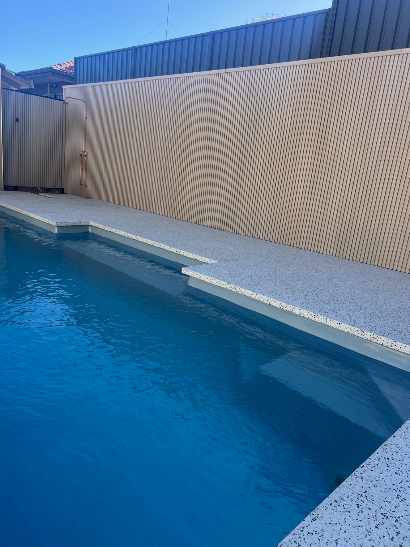 Tan Slat Cladding & Aggregate Paving
